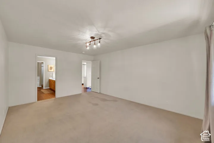 Spacious room, light-colored carpet, with connected bathroom
