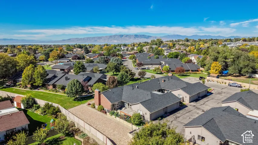 Expansive residential neighborhood with mature trees and mountain scenery