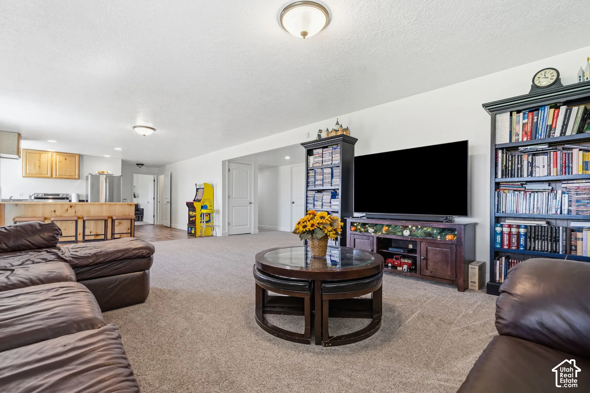 Carpeted living area with overhead lighting