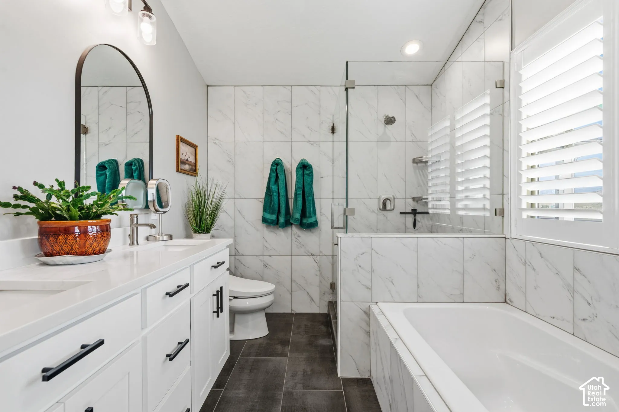 Dual vanity with white cabinetry, quartz-style countertop, and matte black hardware