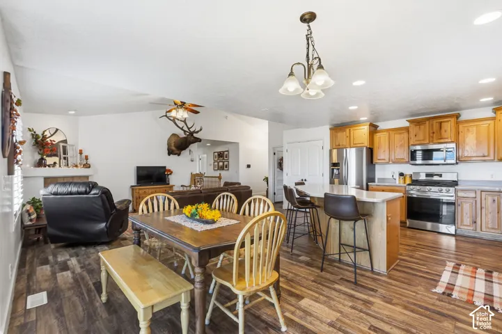 Spacious kitchen featuring stainless steel appliances, light wood-finish cabinetry, and a kitchen island with seating