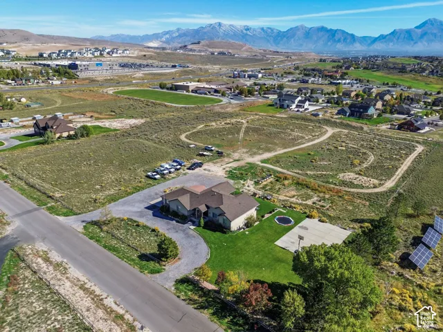 Expansive property featuring a circular driveway, a basketball court, and solar panels