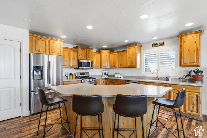 Kitchen featuring wood-finish flooring, recessed lighting, and light wood cabinetry