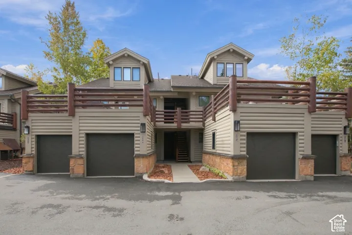 Multi-level exterior with horizontal siding and log-style railing