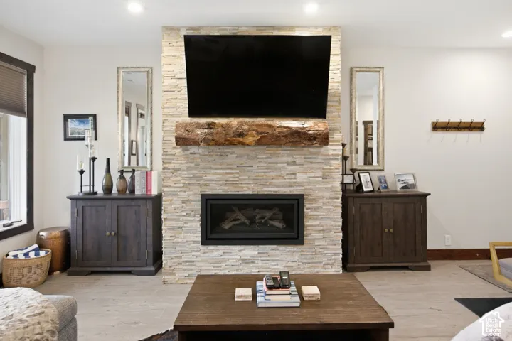 Stone-clad fireplace with a wood mantel and built-in insert