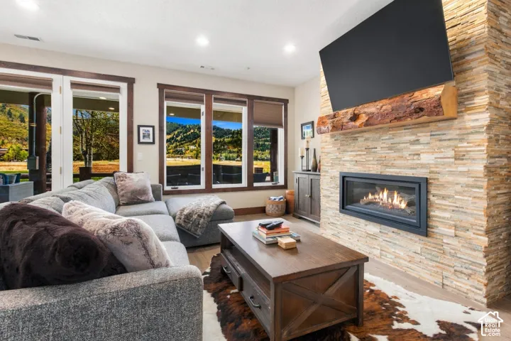 Stacked stone fireplace with a natural wood mantel