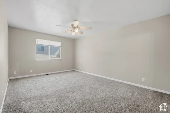 Neutral-toned walls complement the gray carpeting