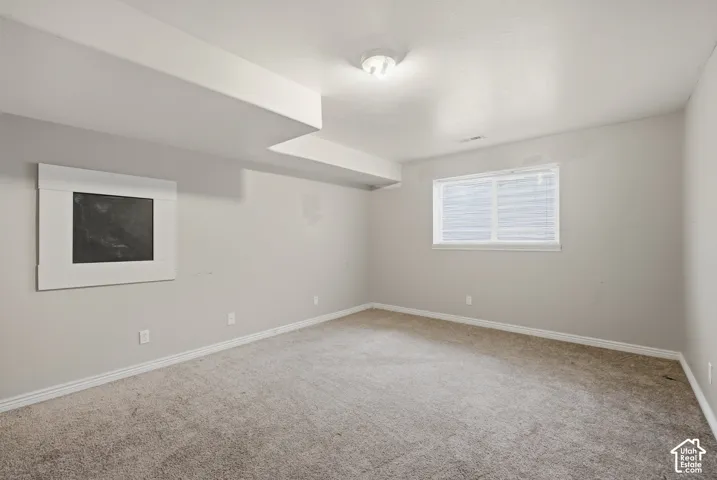 Carpeted flooring, recessed window, ceiling-mounted light fixture, and built-in wall feature