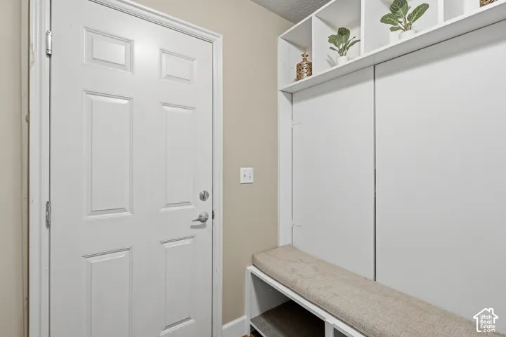 Built-in storage with open shelving, integrated bench seating, and paneled doors