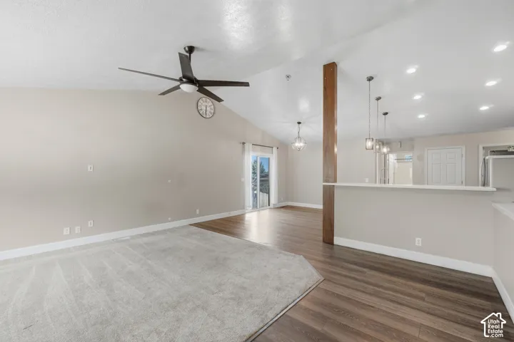 Vaulted ceiling, ceiling fan, sliding glass door, wood-finish flooring, recessed lighting