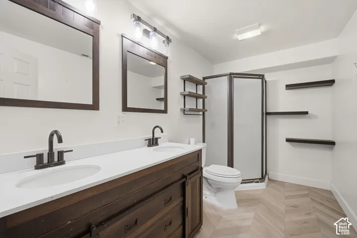 Dual vanity with white countertops and dark-finish cabinetry