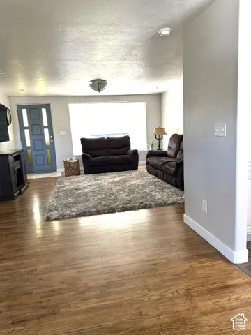 Wood-finish flooring throughout, complemented by light gray wall tones and white baseboards