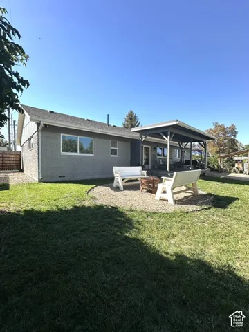 Expansive lawn with a gravel patio area and a covered outdoor living space