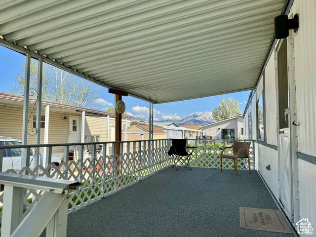 Covered porch featuring a corrugated ceiling and lattice railing