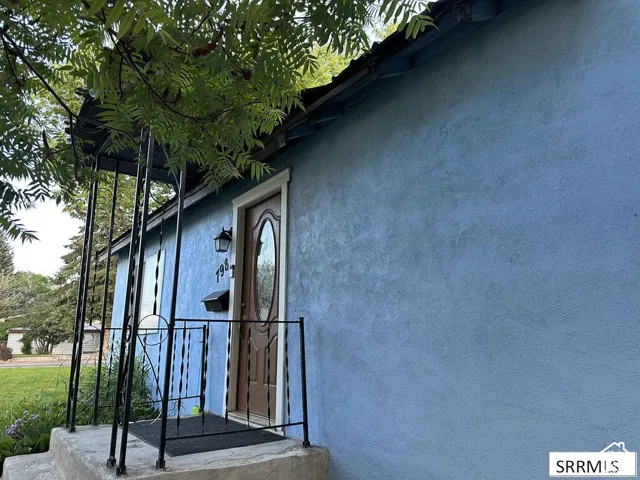 Textured stucco exterior with a covered entry