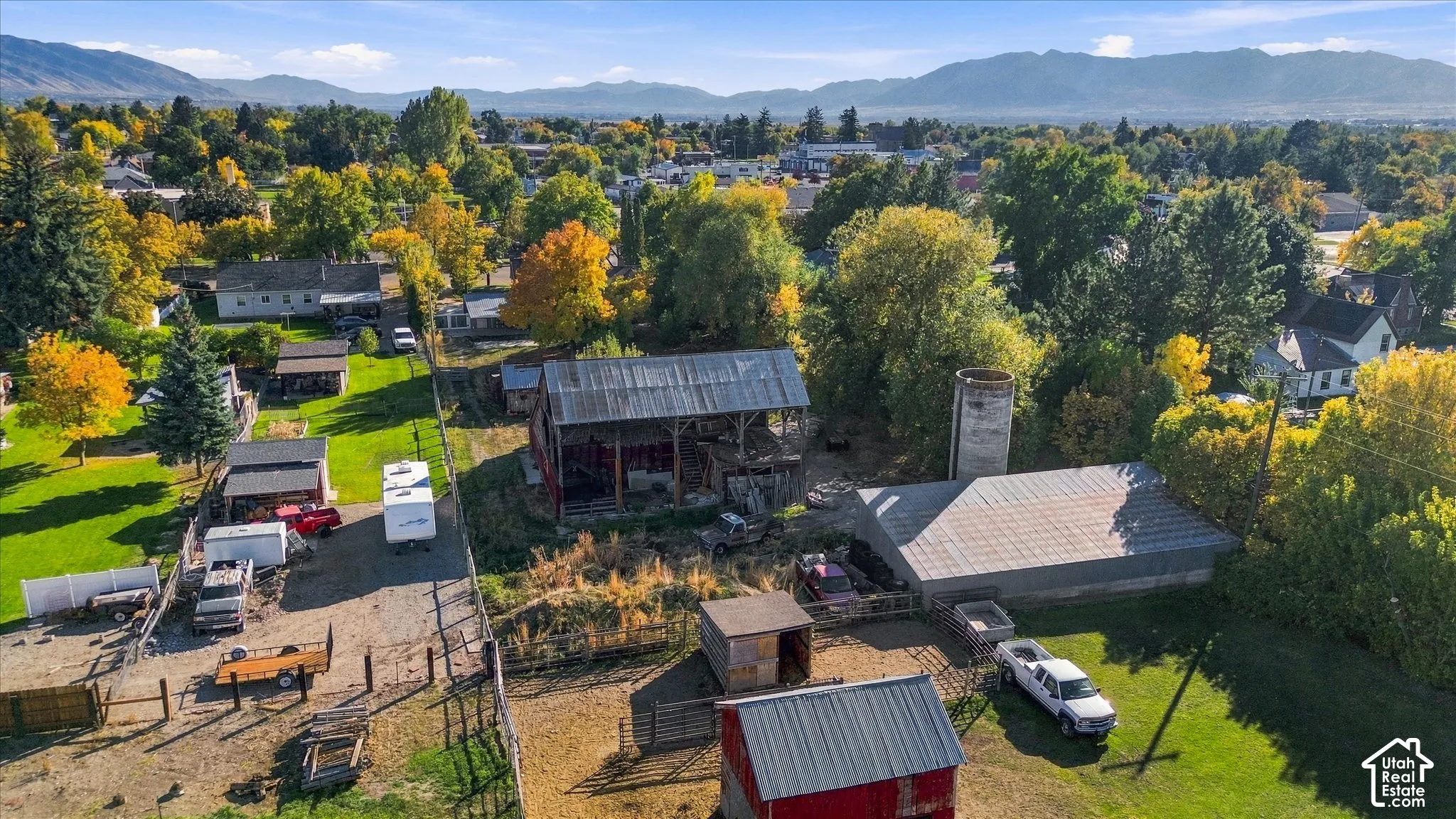 Expansive grounds featuring a red barn, additional outbuildings, and a silo