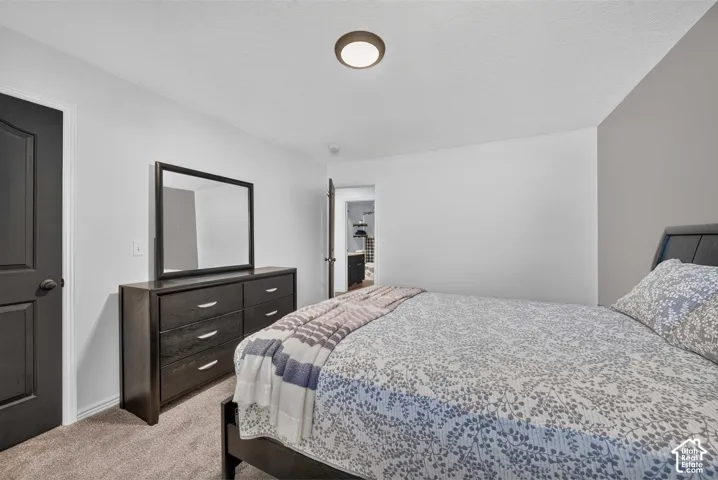Light-colored walls, dark-paneled door, and recessed ceiling lighting