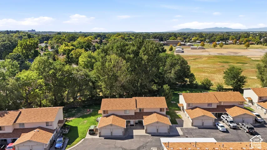 Residential community with multiple townhome-style units, each featuring an attached garage and a private rear yard