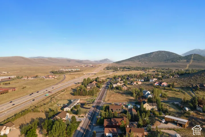Expansive mountain backdrop with a highway and established residential areas