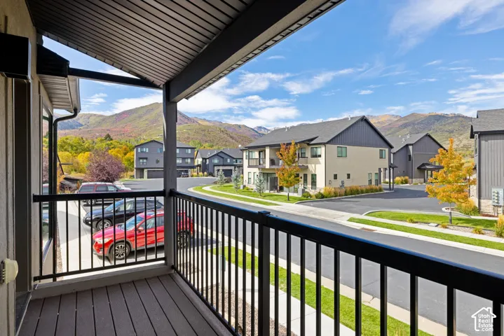 Covered balcony with composite decking and black metal railings