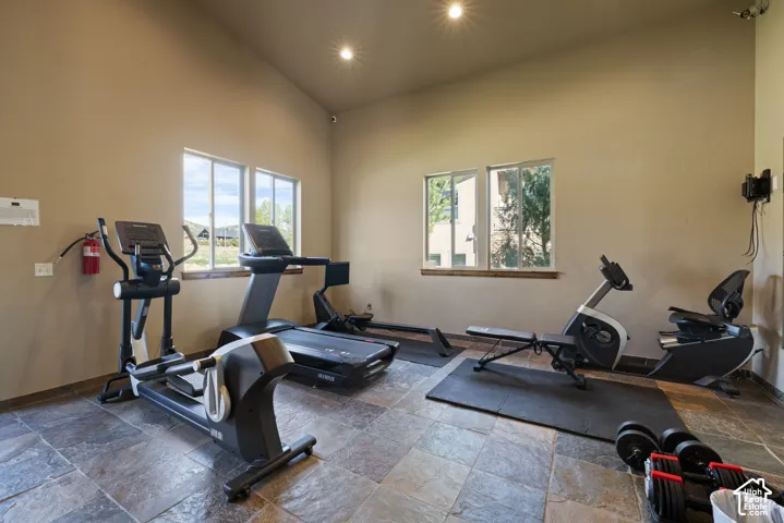 Interior space featuring neutral wall tones, vaulted ceilings, and recessed lighting