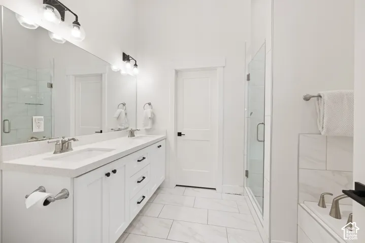 Dual vanity with integrated sinks, brushed nickel fixtures, and white shaker-style cabinetry