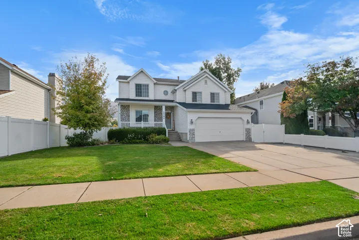 Two-story exterior with white siding and stone accents