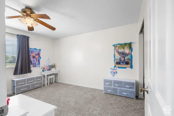 Textured carpeting, white painted walls, and a window with blinds