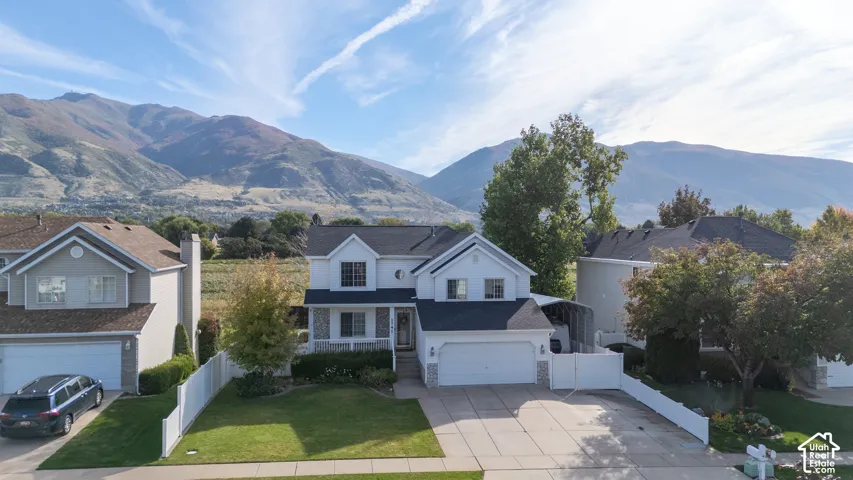 Two-story residence with a two-car garage, stone facade accents, and a covered front entry