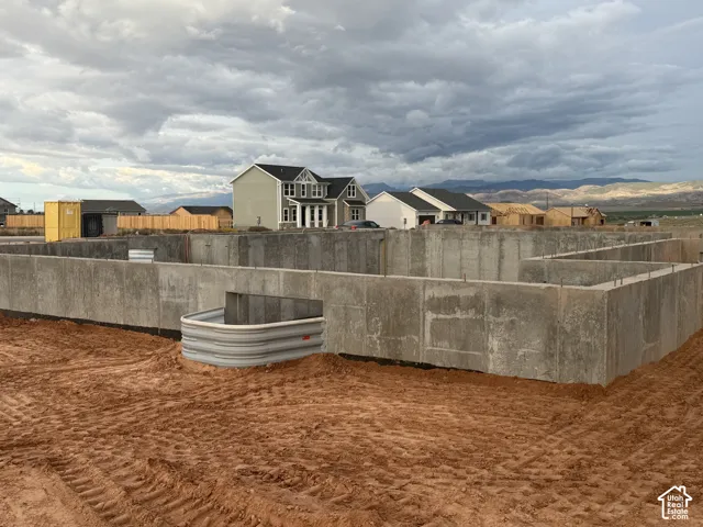 Poured concrete foundation with exposed rebar, featuring multiple window wells