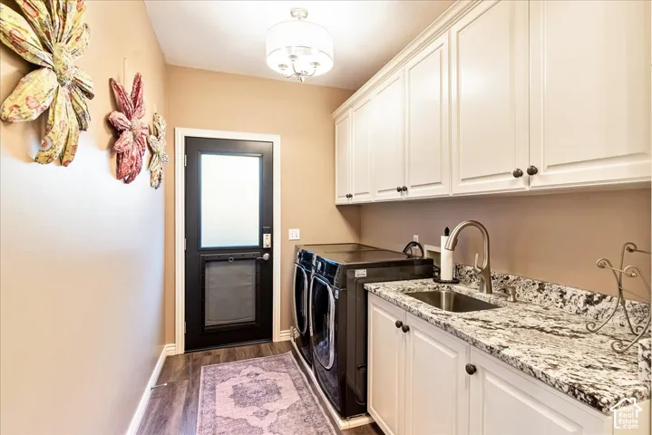 White upper and lower cabinetry, granite-finish countertops, stainless steel sink with gooseneck faucet, and wood-finish flooring