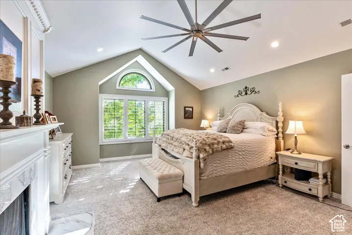 Vaulted ceiling with an oversized ceiling fan, recessed lighting, and a window featuring a half-moon transom
