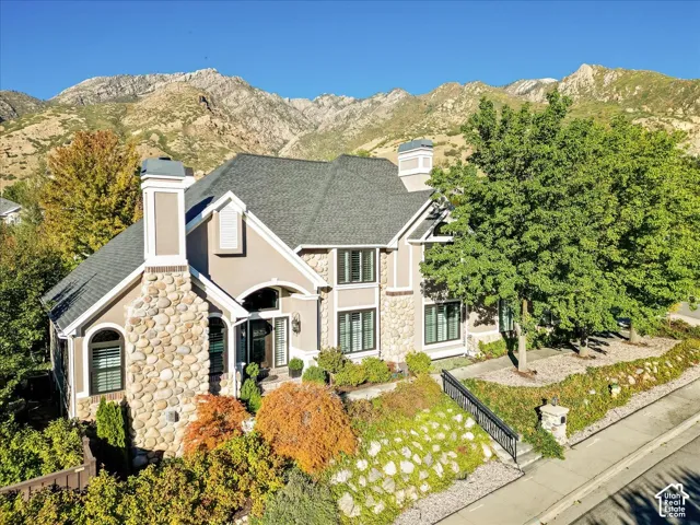Stucco exterior with stone accents and multiple gables