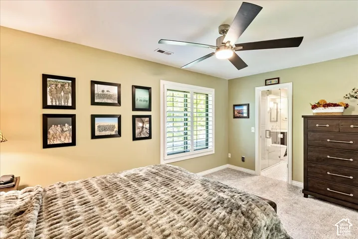 Recessed lighting, ceiling fan with integrated light, window with plantation shutters, glass-paneled door, and neutral-toned carpeting