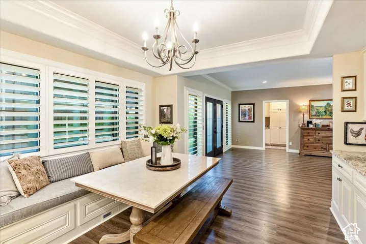 Built-in dining bench with paneling, wood-finish flooring, and white plantation shutters