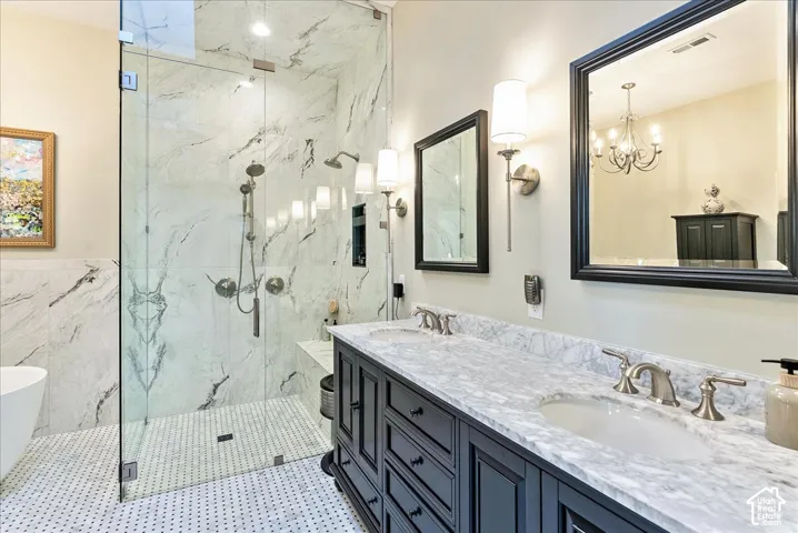 Glass-enclosed shower with marble-finish tile, dual shower heads, and built-in bench