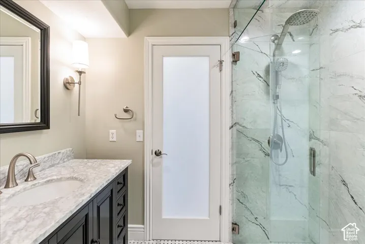 Vanity with stone countertop, undermount sink, and brushed nickel faucet