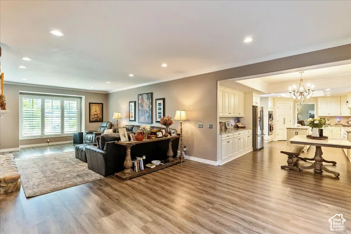 Wood-finish flooring throughout, recessed lighting, and crown molding