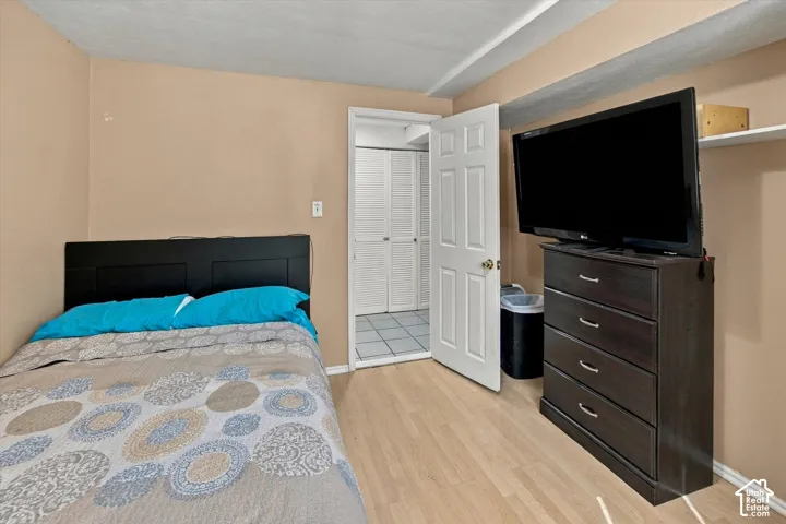 Wood-finish flooring, neutral wall paint, and a built-in wall shelf