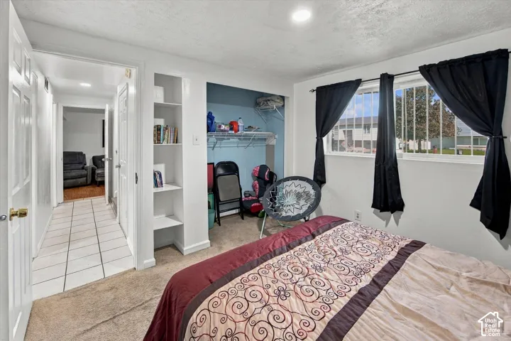 Recessed lighting, built-in shelving, and two windows with security bars