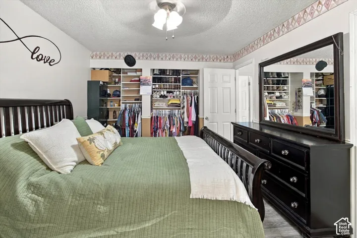 Recessed open shelving, wood-finish flooring, and a ceiling fan with integrated lighting