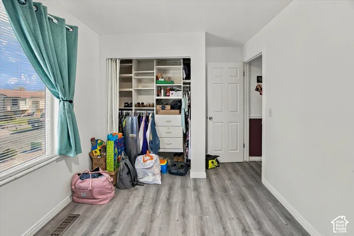 Wood-finish flooring with white baseboards
