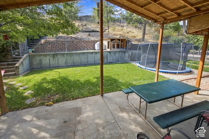 Covered concrete patio with wood-framed ceiling