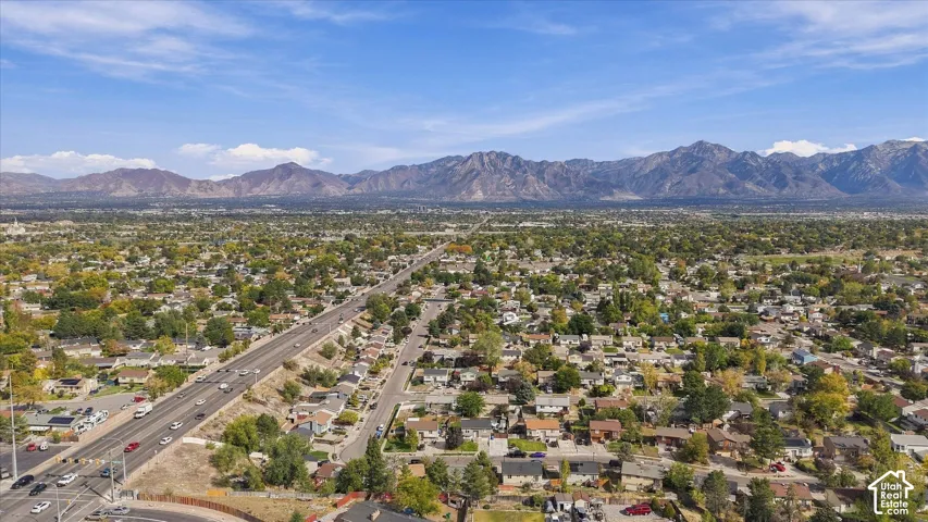 Expansive urban landscape with extensive tree coverage and prominent mountainous terrain