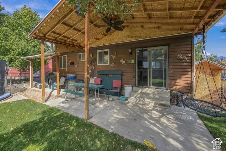 Covered concrete patio with exposed wood beam ceiling
