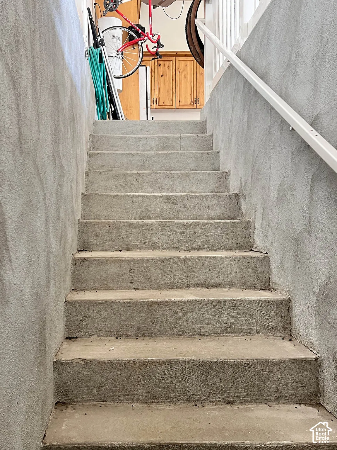 Concrete staircase with textured wall finishes