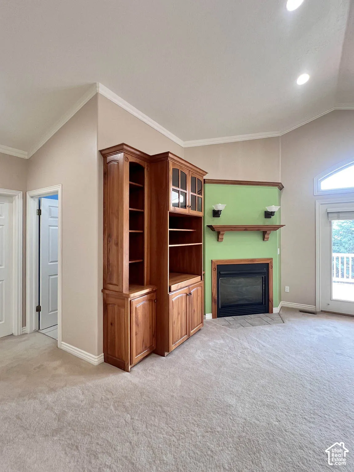 Built-in cabinetry, recessed lighting, and a fireplace with a wood mantle