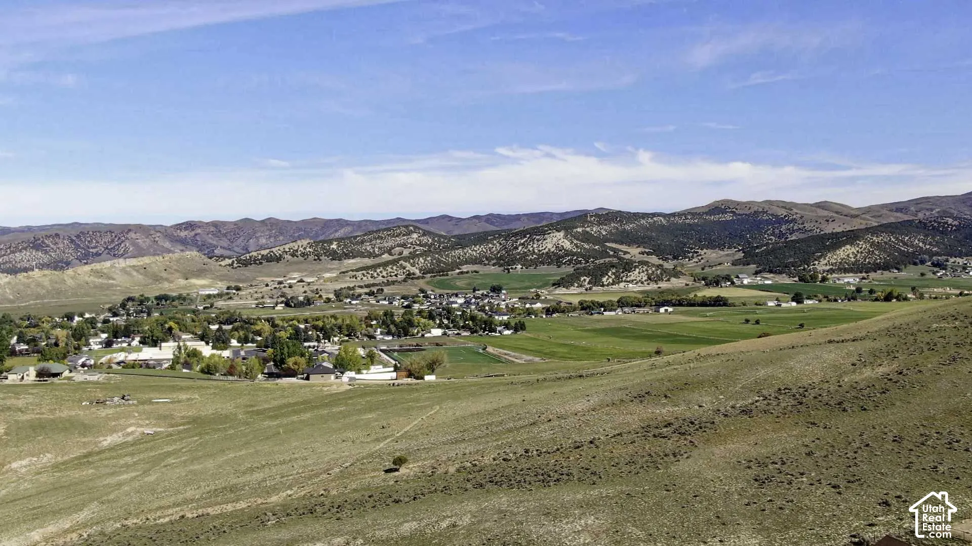 Expansive landscape featuring rolling hills and distant mountains