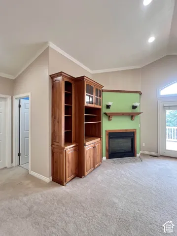 Built-in cabinetry, recessed lighting, and a fireplace with a wood mantle