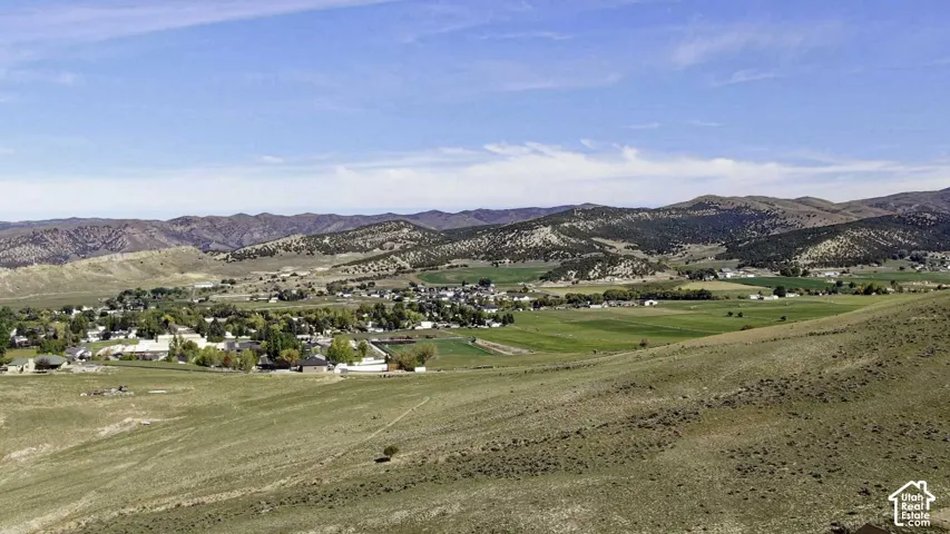 Expansive landscape featuring rolling hills and distant mountains